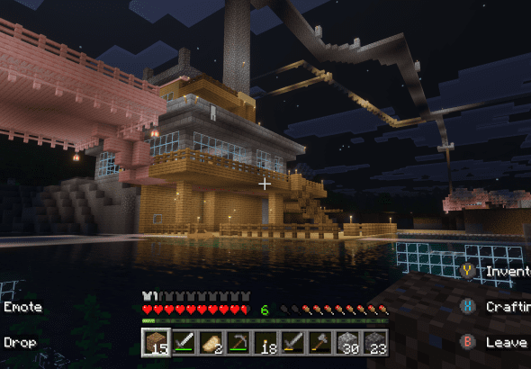 Minecraft waterside fortress with docks, lanterns, and layered design at night in the VIG Realm.